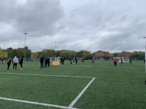 Group of children playing football on an astro turf pitch