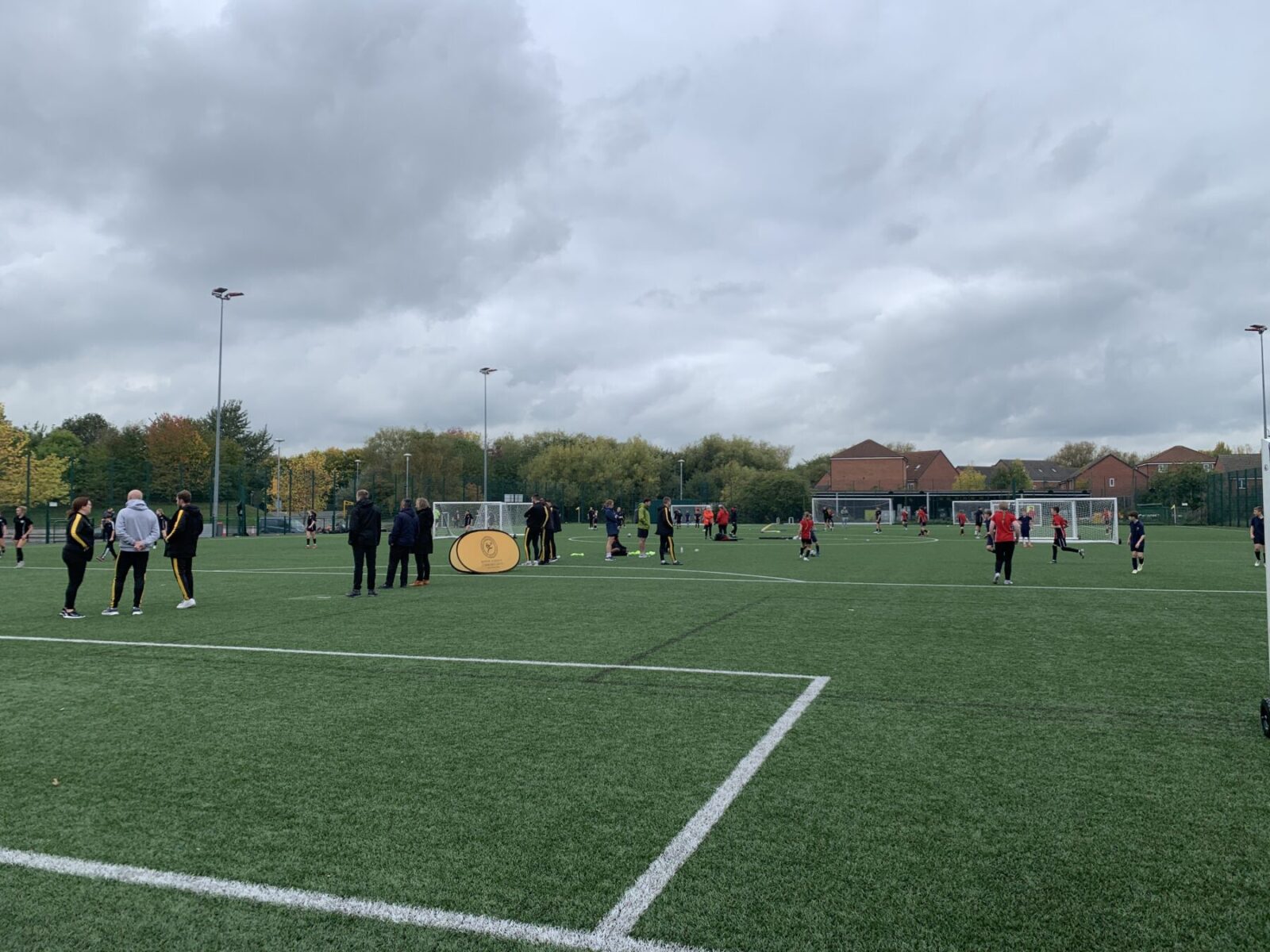 Group of children playing football on an astro turf pitch