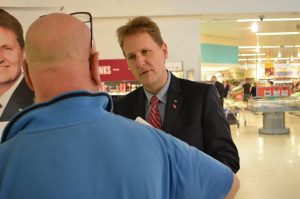 Matthew Ellis talks to shoppers