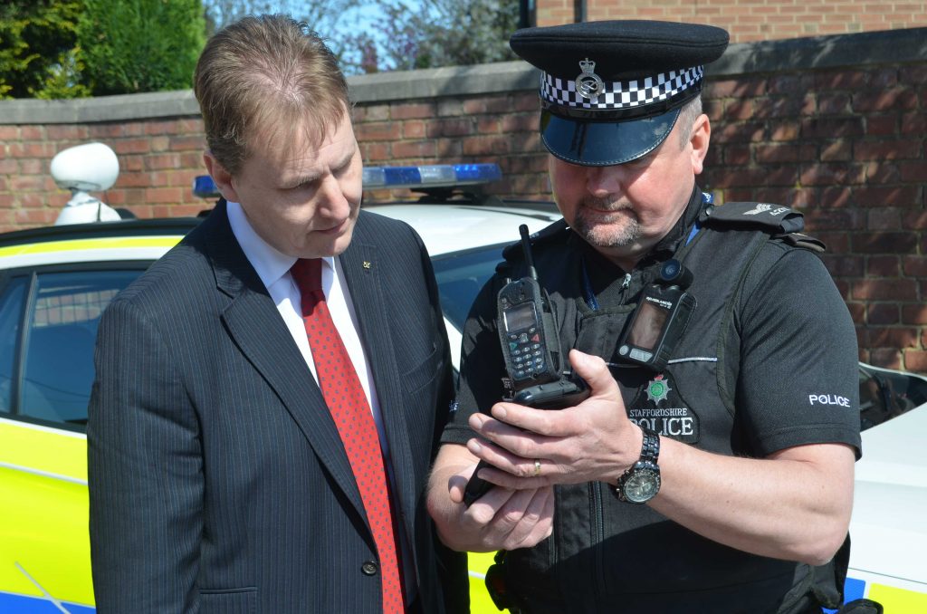 PCC Matthew Ellis and Sgt Tyrone Kerr looking at the mobile device