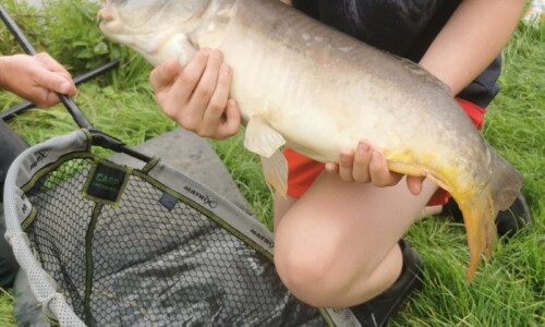 young person holding a fish at Space activity